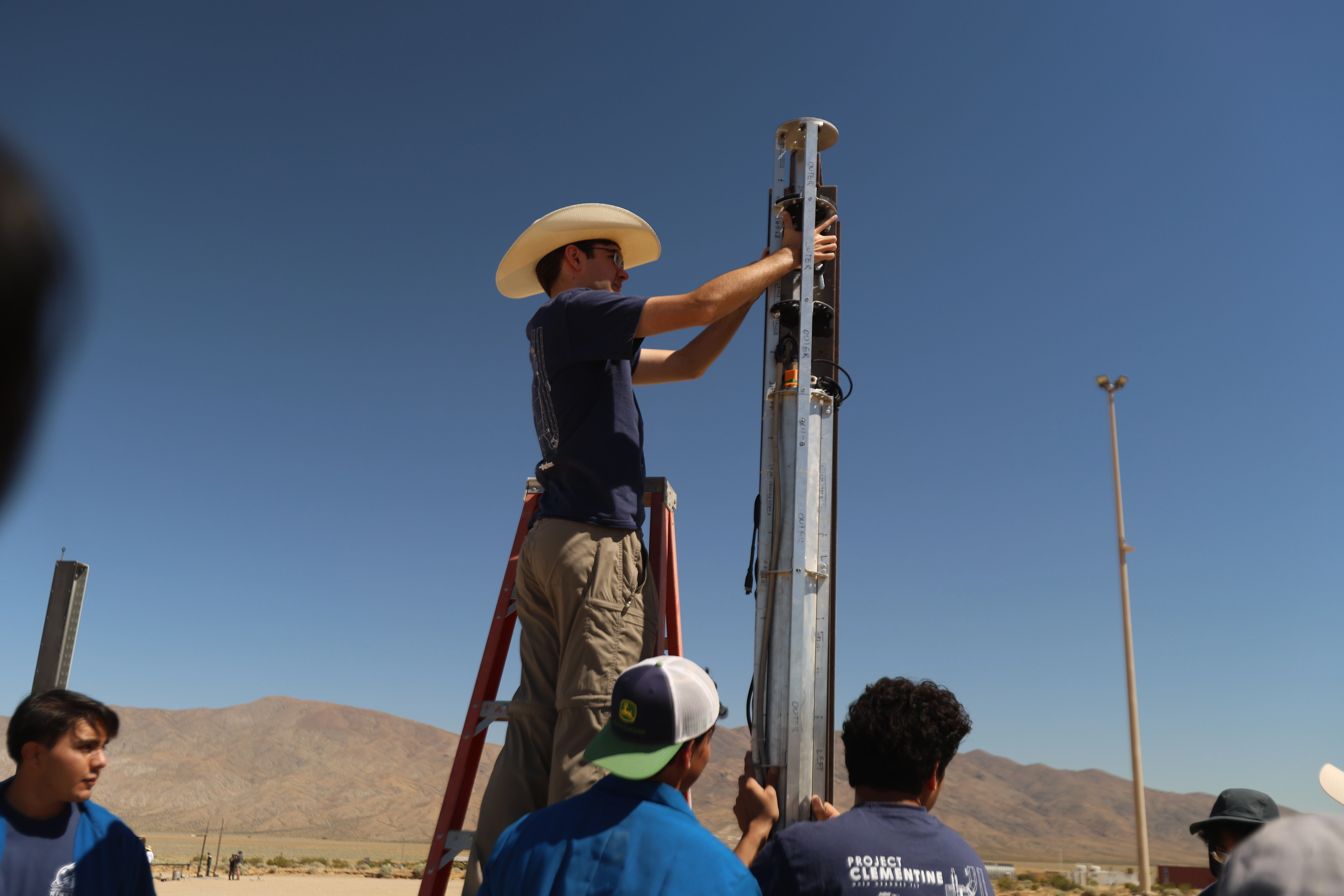 HSP students preparing their rocket at the desert launch site