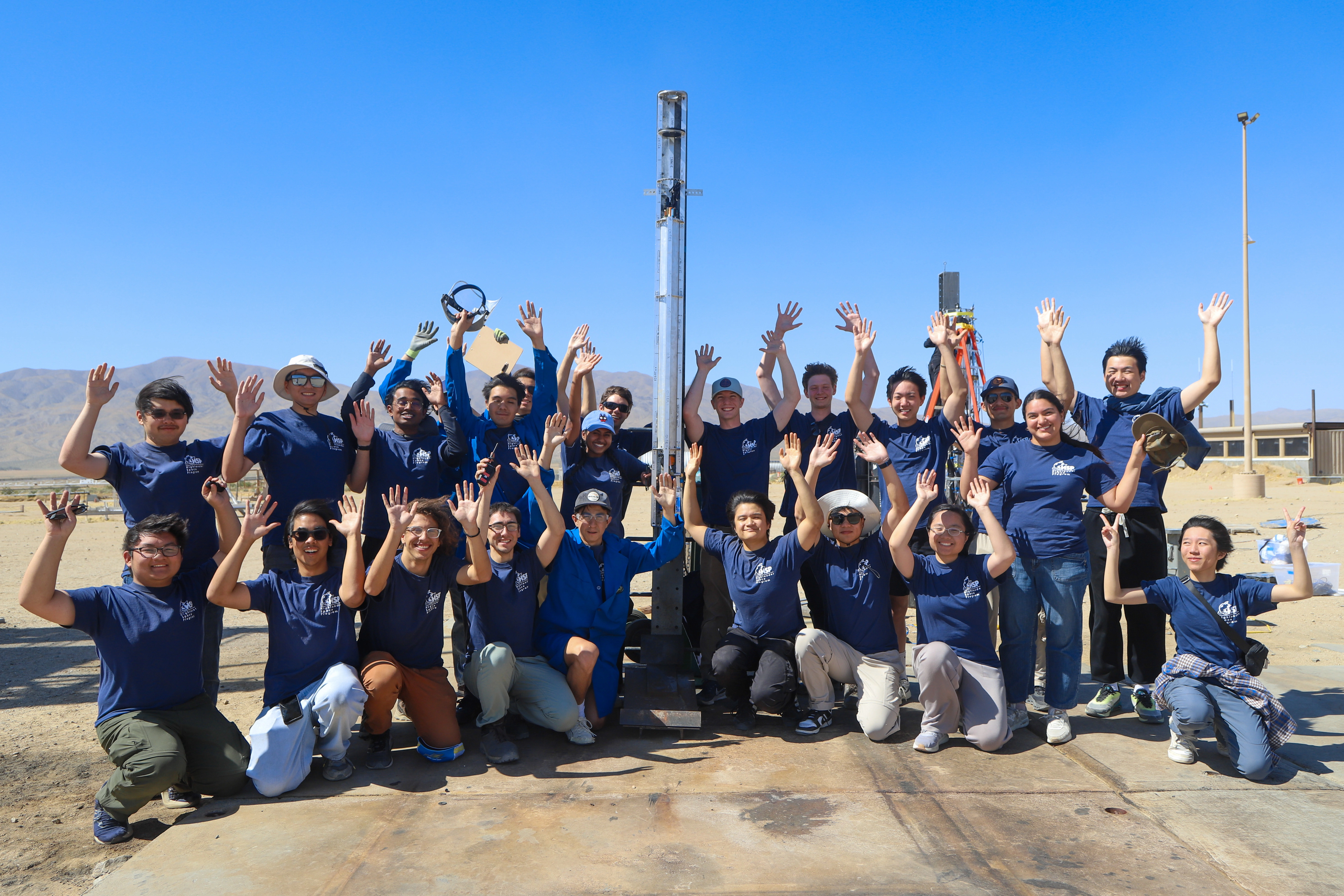 HSP team celebrating together beneath a bright desert sky